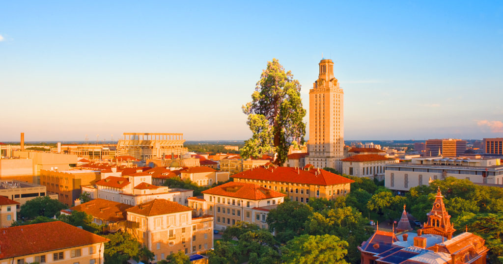 UT Tower pictured among the campus buildings and shown against a bright blue on a sunny day