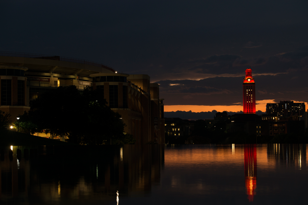UT Tower Glowing orange showing a 5 at a distance in the evening