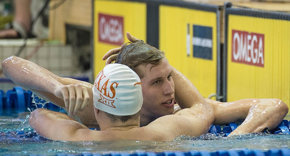 Two swimmers shown in the pool after a swimming match. 