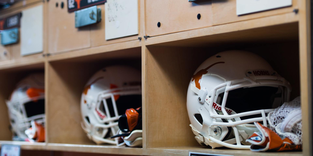 Texas football helmets in locker room