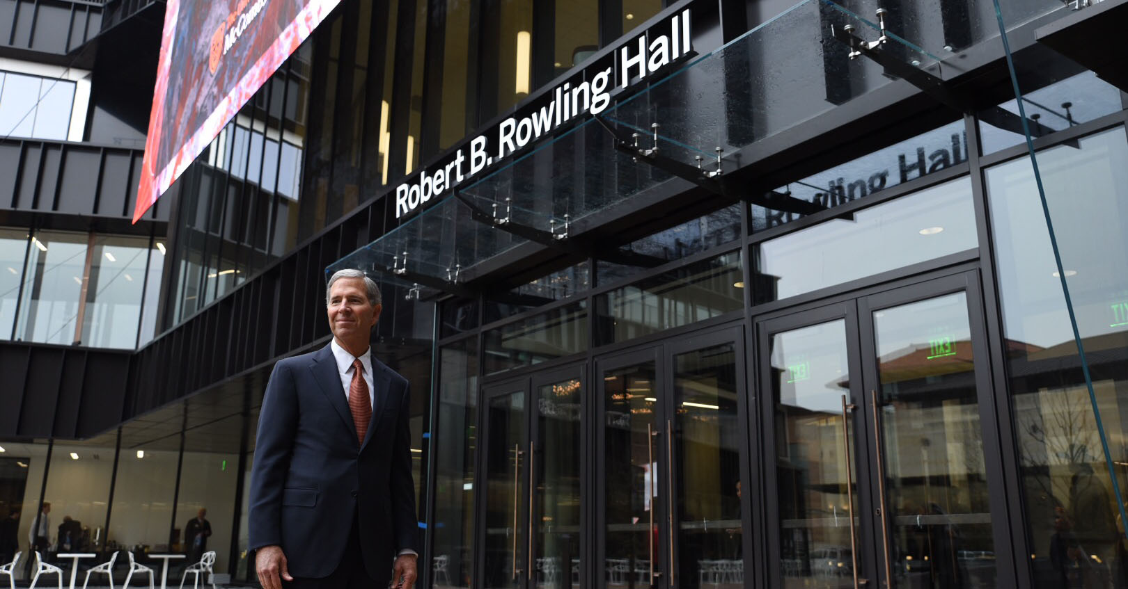Robert Rowling poses in front of Rober B. Rowling Hall. 