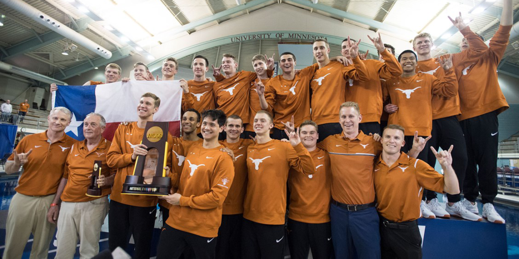UT Mens swimming and diving team with trophy. 