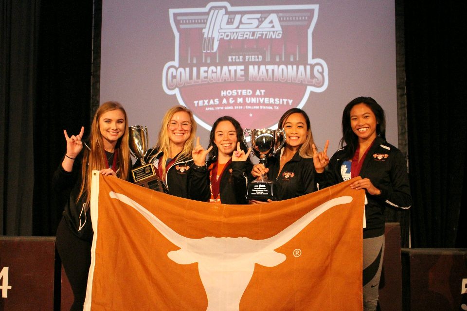 UT Women's Powerlifting team with trophy.