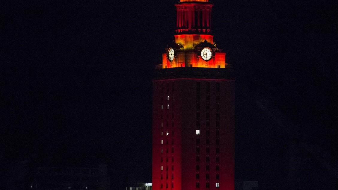 UT Tower lit with orange lights at night.