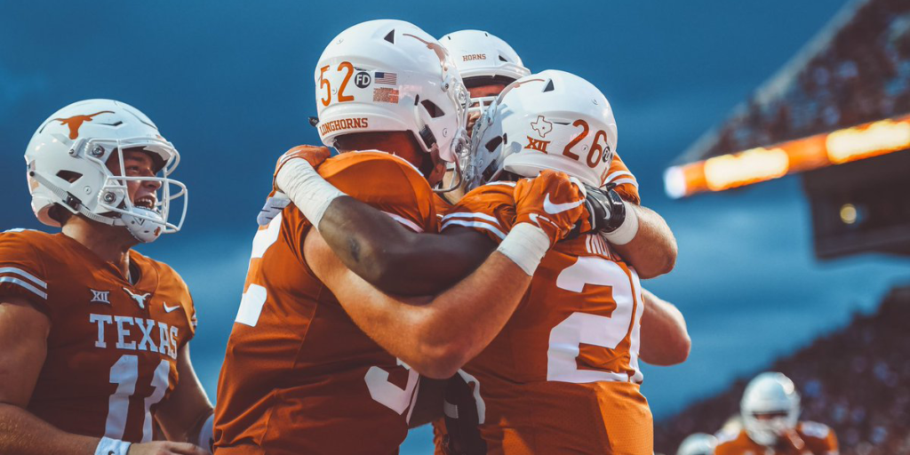 Texas football players celebrate on the field