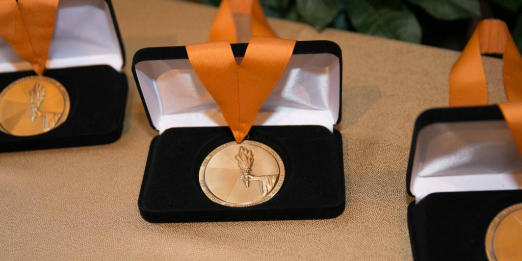 photograph of three medals for the Academy of Distinguished Teachers honors.
