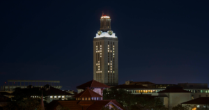 The UT Tower shines with white lights and the number “41” displayed on its sides.