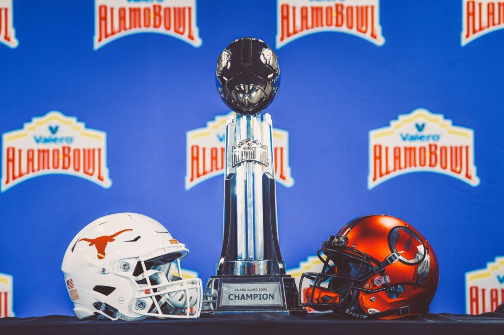 Alamo Bowl trophy, Texas football helmet and Utah football helmet. 