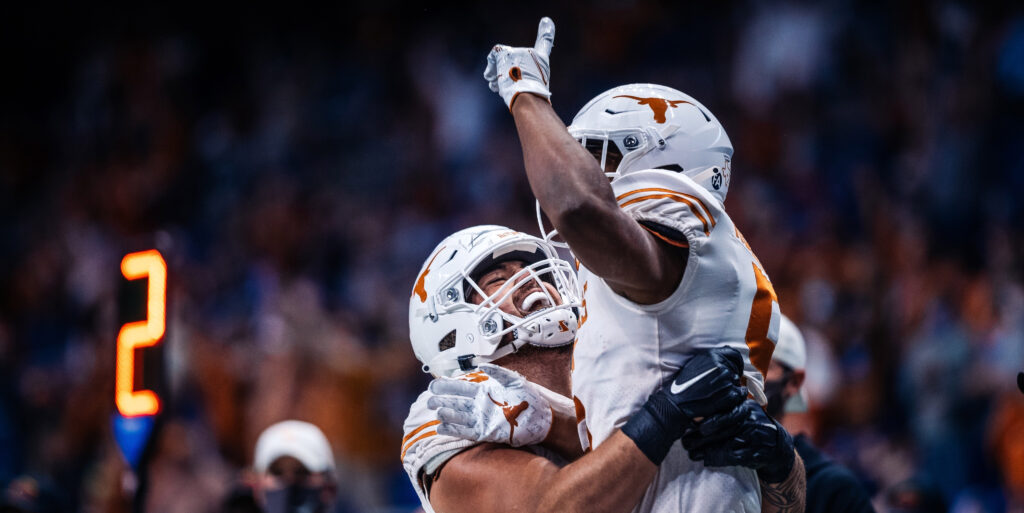 Two Texas football players celebrate