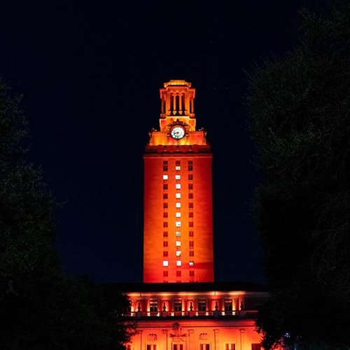 The UT Tower shines with burnt orange lights and "1" displayed on its sides.