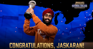 UT Austin student Jaskaran holds up a trophy while on the Jeopardy! game show.