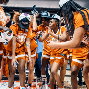 Members of the Texas Women's Basketball team celebrate after winning the Big 12 Conference tournament.