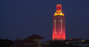 The UT Tower shines with burnt orange lights and the number 1 in the windows.