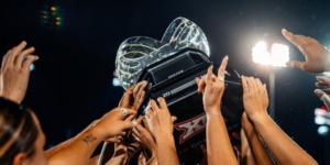 The women Texas Soccer team holds up their trophy after winning the Big 12 Conference.