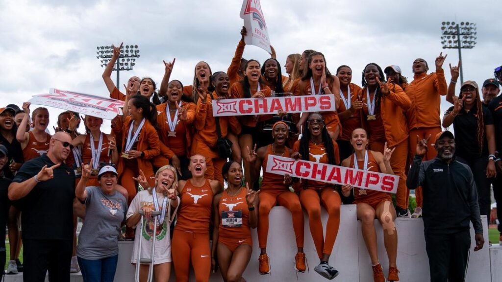 Group photo of Texas women's track and field team celebrating after winning the conference championship. 