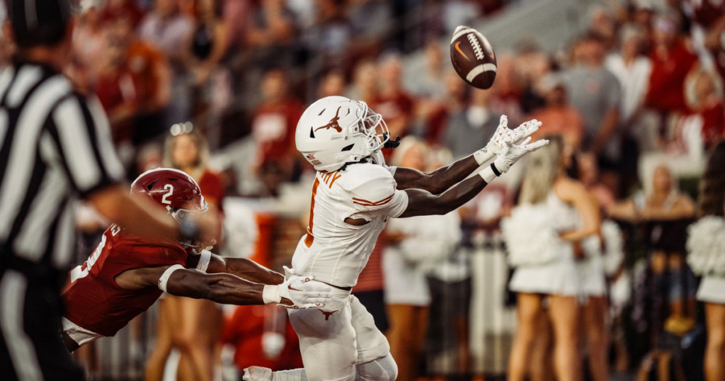 A Texas football player catches the ball.