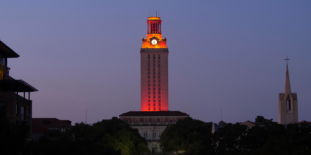 U.T. Tower shines with burnt orange lights in front of the night sky