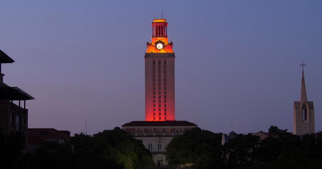 U.T. Tower shines with burnt orange lights in front of the night sky
