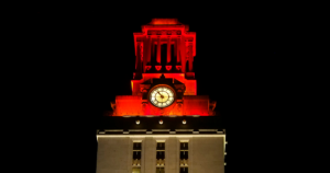 The top of the U.T. Tower shines with burnt orange lights
