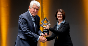 Bob Metcalfe, professor emeritus in the Chandra Family Department of Electrical and Computer Engineering at The University of Texas at Austin, and Diana Marculescu, chair of UT’s Department of Electrical and Computer Engineering pose for a picture while holding a small statue that is the A.C.M. A.M. Turing Award.