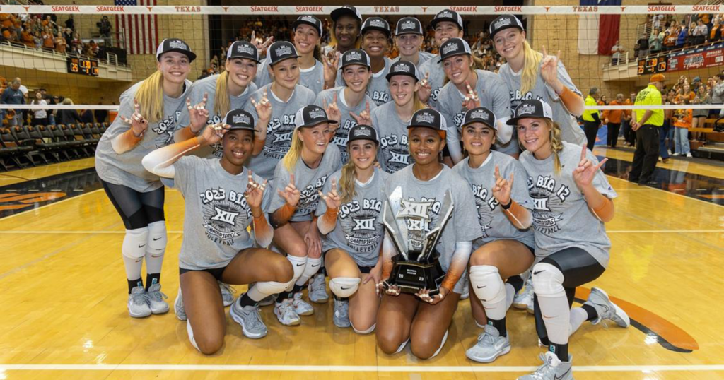 The Texas Volleyball team takes a celebratory photo with the 2023 Big 12 Conference Championship trophy.