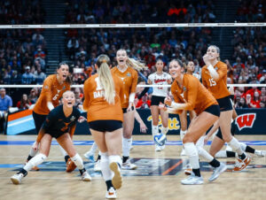 Texas Volleyball players celebrate on the court