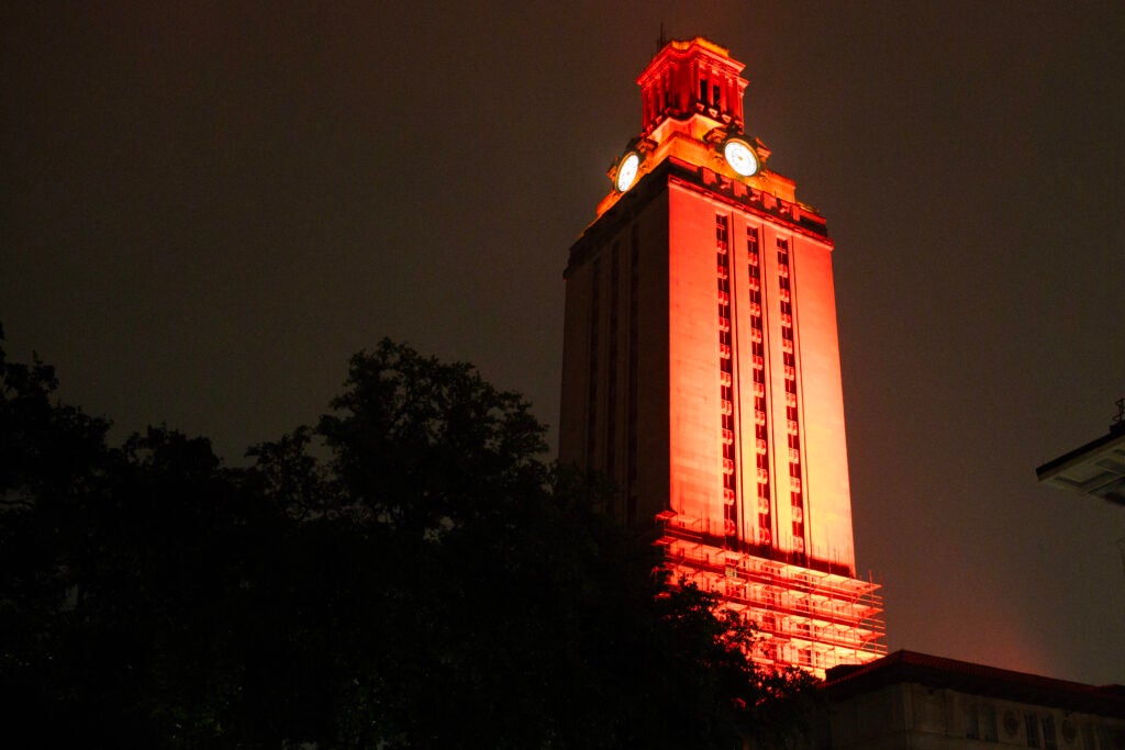 The University of Texas at Austin Tower lit with burnt orange lights.