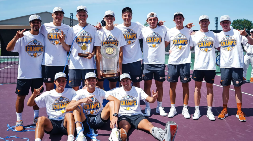 The 2026 UT men's tennis team poses on a tennis court with the SEC championship trophy.